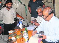 Officials of the Excise and Taxation Department and the Legal Metrology Department conduct a raid on a tavern at Sector 17, Chandigarh, on Tuesday.