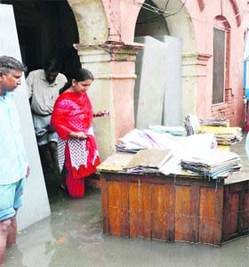Mayor Renu Bala Gupta inspects the flooded Municipal Corporation building in Karnal after a downpour on Tuesday