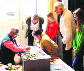 Artist Vijay Sharma demonstrates Kangra painting techniques to lovers of the art in Hamburg, Germany.
