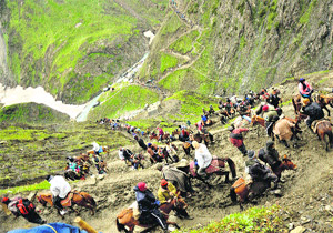 Pilgrims pass Sangam while on their way to the Amarnath shrine.