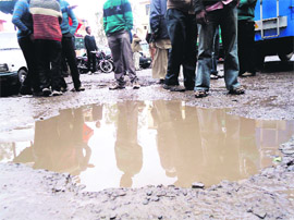 Rainwater accumulates outside the Rajouri bus stand in Rajouri.