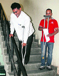 A physically challenged man finds it difficult to climb stairs at the District Administrative Complex in Jalandhar on Monday