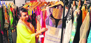 A visitor looks at wedding apparels on the opening day of an exhibition in Ludhiana on Tuesday. 