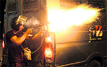 An Egyptian riot policeman fires tear-gas shells towards pro-Mursi supporters during clashes in Cairo