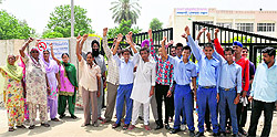 Students and their parents stage a protest outside the Adarsh School in Bathinda on Wednesday