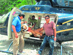 Officials of the Animal Welfare Board and the People for Animals on Tuesday rescue a mule that remained stranded on rocks in the Mandakini river at Sonprayag after the natural disaster. 