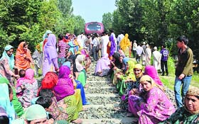 Residents of Chidhama village in Kulgam district block the railway track near their village on Wednesday