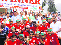 State Bank of Travancore, Kerala, celebrate after winning the ONGC All India Football tournament at the Paddal ground on Wednesday. 