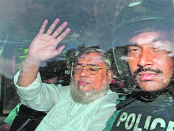 Jamaat-e-Islami secretary general Ali Ahsan Mohammad Mojaheed (L) waves from a police vehicle in Dhaka on Wednesday. 