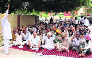 Class-IV employees of the Government Rajindra College staging a demonstration demanding regularisation of their services in Bathinda on Thursday.