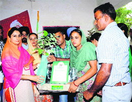 Harsimrat Kaur Badal giving away saplings under Nanhi Chaan project on Thursday.