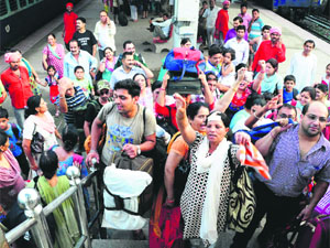Passengers of the Bharat Darshan train raise slogans against the railway authorities at the Chandigarh railway station on Thursday. 