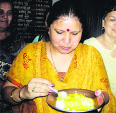 Haryana Education Minister Geeta Bhukkal partakes of mid-day meal at a school near Ambala City.