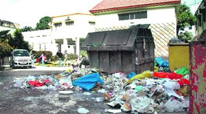 Garbage lying outside a bin in Dehradun on Thursday. 