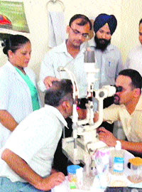 Dr Himanshu Bhatnagar examines a patient at a free eye check-up camp organised by the Sikh Youth Club in the Meeri-Peeri Institute of Medical Science and Research, Shahabad. 