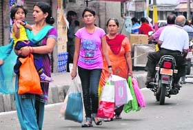 Shoppers carry goods in banned polythene bags in Jammu on Thursday