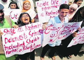 Placing demands: Family members of Imran and Farhad, who have been sentenced by a Kolkata court for their involvement in carrying weapons, hold placards during a protest