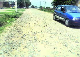 A car passes through an unmetalled road at Jagraon Grain Market