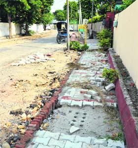 Interlocking tiles that are being fixed on Club Road in Ludhiana