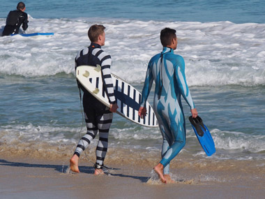 This Shark Attack Mitigation Systems (SAMS) handout photo received on Thursday shows a surfer (L) and a diver (R) wearing wetsuits displaying the two styles of SAMS shark deterrent technology, with the surfer holding a surfboard also showing the new design.