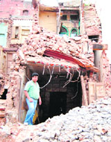 Shopkeeper Sanjiv Kumar shows the shop which was allegedly robbed and damaged by a SAD leader and his relatives in Amritsar.
