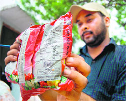An official shows a packet of salt whose expiry date had elapsed in government schools in Amritsar on Friday.