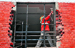 Workers remove encroachments from EWS houses at Sector 19-C in Chandigarh on Friday