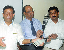 Doctors launch an advanced prosthetic hand that can be controlled through a mobile application for road accident victims or those congenitally devoid of arms, during a press conference in New Delhi on Friday