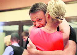 Russian opposition leader Alexei Navalny embraces his wife Yulia at a courtroom in Kirov, Russia, on Friday.  AP/PTI