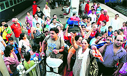 Passengers of the Bharat Darshan train raise slogans at the Chandigarh railway station