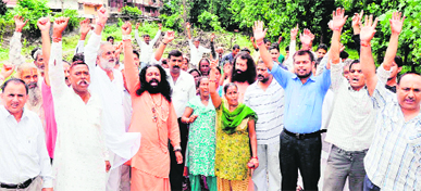Aggrieved saints and local people protest against the rise in the number of fake registries of religious properties in the Saptsarovar area of Haridwar on Saturday.