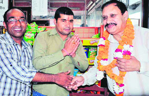 Residents felicitate former police in charge of the Kanwar mela Kiran Lal Shah at Ranipur  in Haridwar on Saturday. 