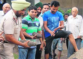 A policeman inspects the bomb shells found in Jalandhar on Saturday