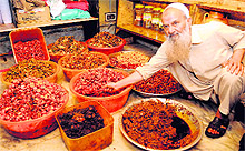 Ghulam Qadir Sanoo displays different pickle varieties at his shop in the Habba Kadal locality of Srinagar