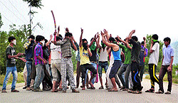 Youth protest against the killing of four civilians in BSF firing, in Anantnag