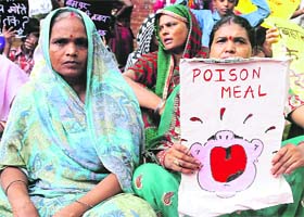 An activist holds a banner in protest against the death of 23 schoolchildren, in New Delhi on Saturday