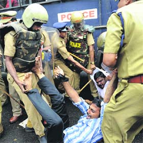 The police arrests activists protesting against Kerala CM Oommen Chandy over the solar scam in Kozhikode on Saturday