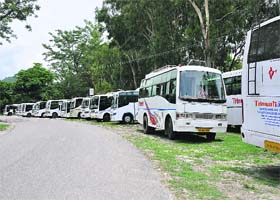 Tourist buses for Char Dham pilgrimage parked idle in Haridwar