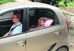 (Right) The child is secure in a child seat with a lock 