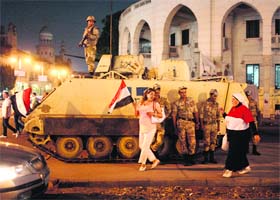 Soldiers around an armoured personnel carrier near the presidential palace in Cairo on Friday