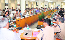 Garhwal Commissioner Subardhan presides over a meeting to reveiw preparations for the Kanwar mela at CCR Tower in Haridwar on Sunday; and