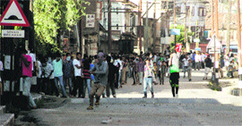 Protesters throw stones on police and CRPF personnel in Srinagar on Sunday.