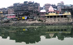 Images of past: Shadows of old, rickety, multi-storied houses and an ancient temple loom in the waters of rive Jhelum in Habba Kadal locality of downtown Srinagar on Sunday