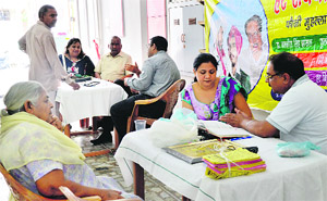 Doctors examine patients at a medical check-up camp organised by the Rama Charitable Trust at the Kochhar Market in Ludhiana. 