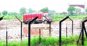 A Pakistani truck loaded with gypsum parked at a waterlogged area at the Integrated Check Post in Attari on Sunday