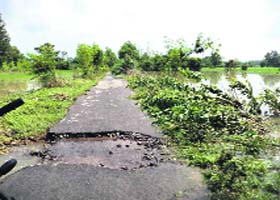 The receding waters left behind damaged roads and fields in Anandpur villages on Sunday