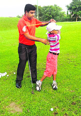 Seven-year-old Aditya Sood learns the tricks of the trade at Chandigarh Golf Range. 