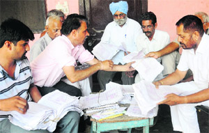 Residents have a tough time searching for their electricity bills at Burail village in Chandigarh. 