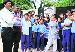 District Education Offier Mewa Singh interacts with the protesting students at Phase IX, Mohali, on Monday. 