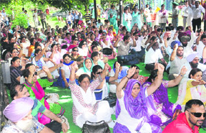 Members of the Joint Action Committee of UT schoolteachers protest at Sector 20 in Chandigarh on Monday. 